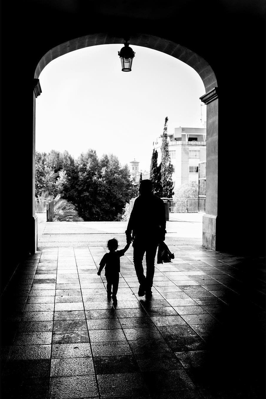 Adult and child beneath an arch